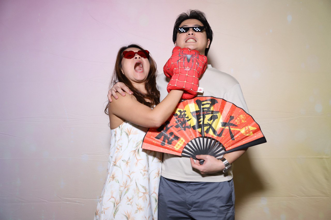 Couple and guests at wedding photobooth